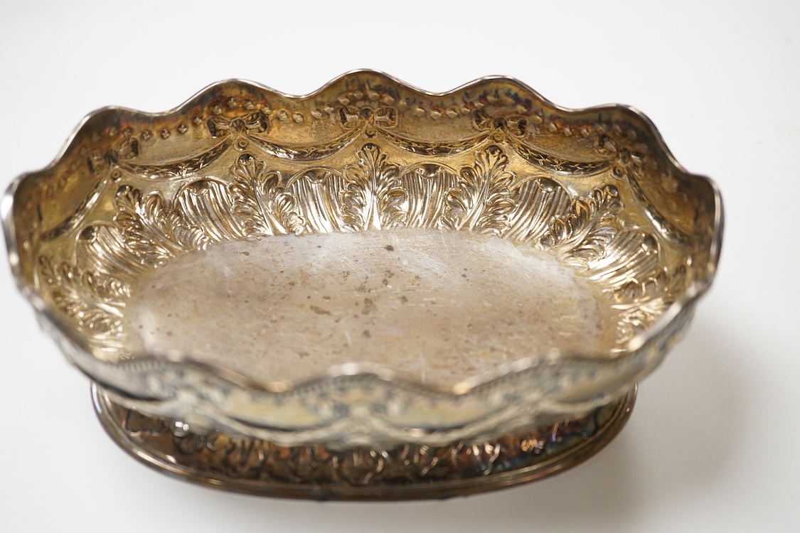A late Victorian embossed silver oval bowl, by Charles Stuart Harris, with engraved initials to the base, London, 1890, length 16.4cm, 7.3oz.